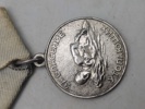 Original sovjetisk medalje kendt som "Medal for Saving the Drowning" (Медаль «За спасение утопающих»).