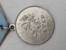 Original sovjetisk medalje kendt som "Medal for Saving the Drowning" (Медаль «За спасение утопающих»).