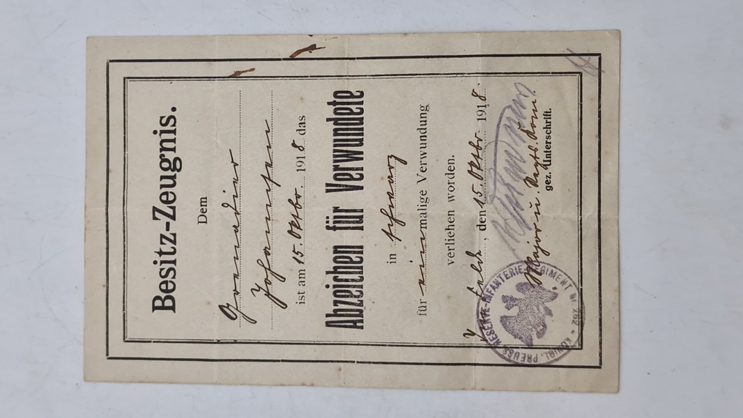 Originalt Dokument "Besitz-Zeugnis" (ejerbevis) for en Grenadier Johansen, dateret 15. oktober 1918. Det bekræfter, at Johansen er blevet tildelt "Abzeichen für Verwundete"