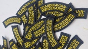 broderede navnemærker med teksten "SCANDINAVIAN MERCENARIES"