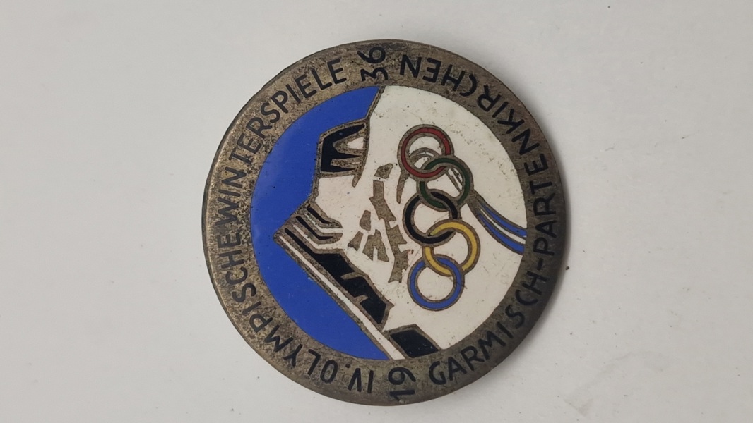 originalt badge fra de IV. Olympiske Vinterlege, der blev afholdt i Garmisch-Partenkirchen, Tyskland, i 1936